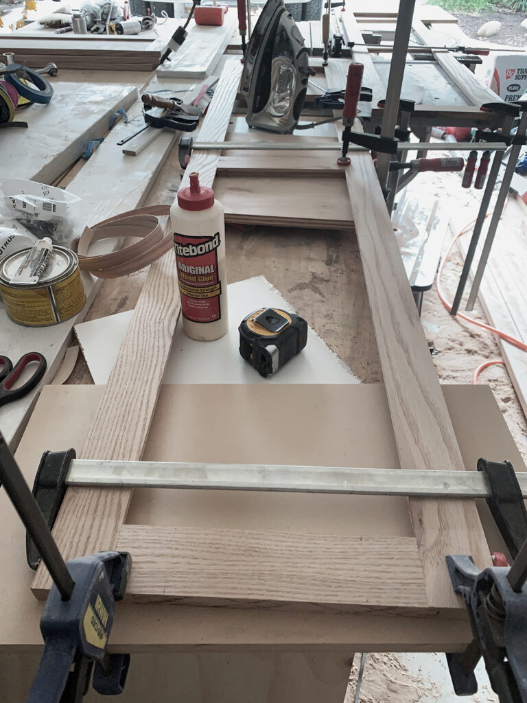beautiful 3/4" white oak plywood 60" shaker panel door, glued with titebond glue and clamped up ready for a glass panel insert.
