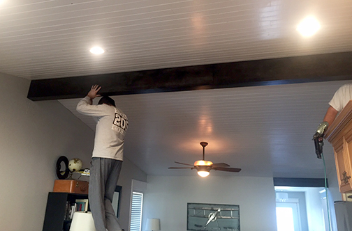three people were required to lift the faux wood beam in to place. Two to hold it up, while one person nailed it with the finish gun.