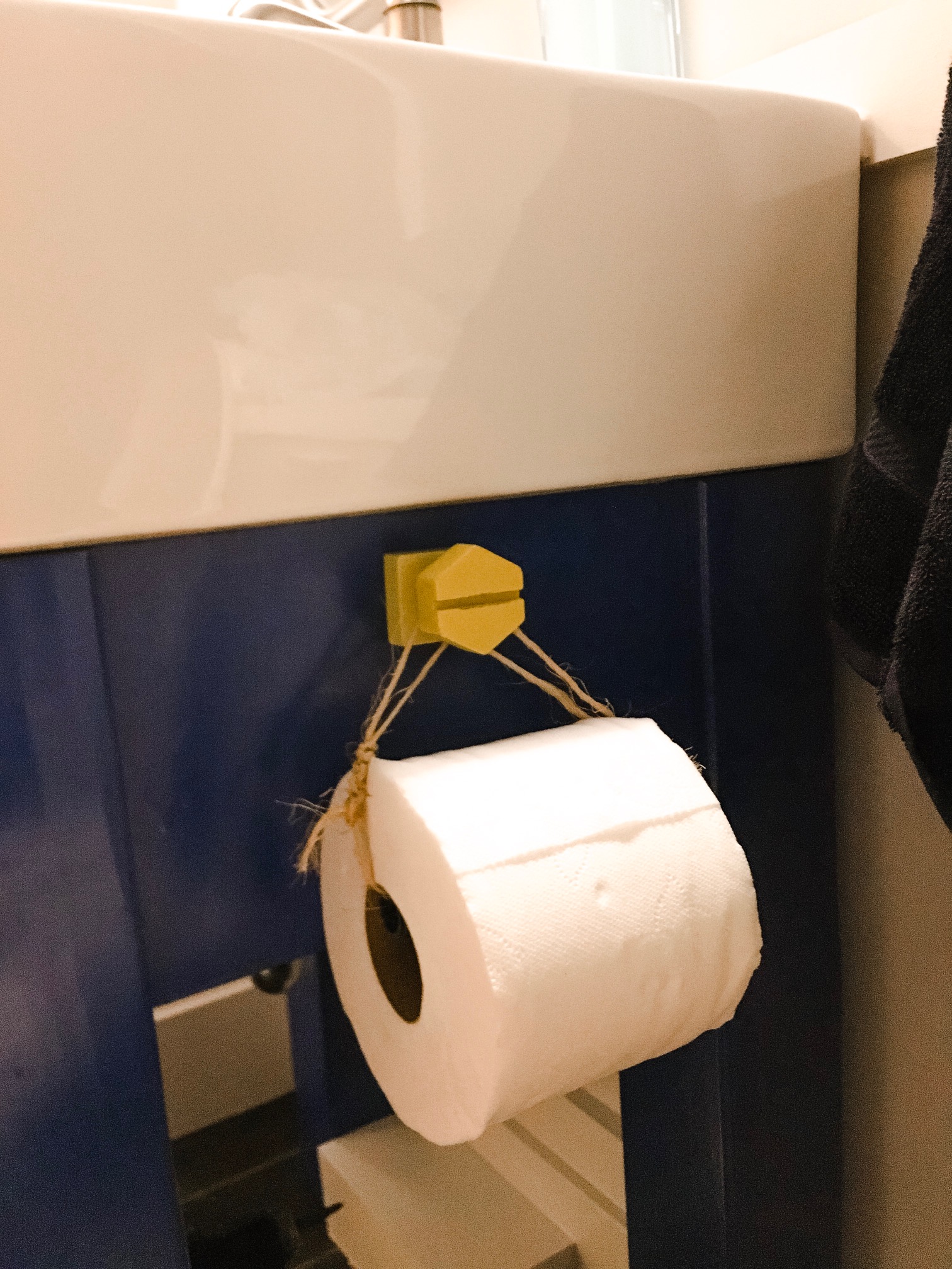 toy bolt repurposed as a toilet paper roll holder was a custom and cute addition to this quick and easy boy bathroom remodel