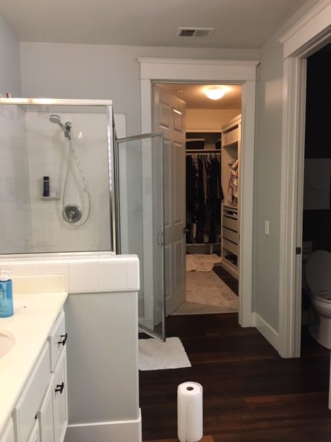 Looking towards the closet. Single, worn plastic shower head and small soap dish were the only features of this dated shower.