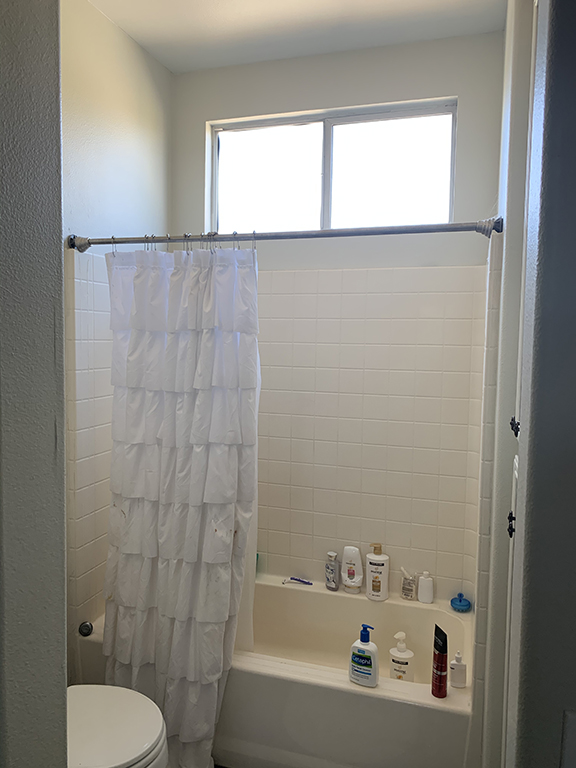 before shower tub combo with builder standard fiberglass insert that was yellowed, cracked and ready for an update. replaced with tiled shower and fixed glass panel.