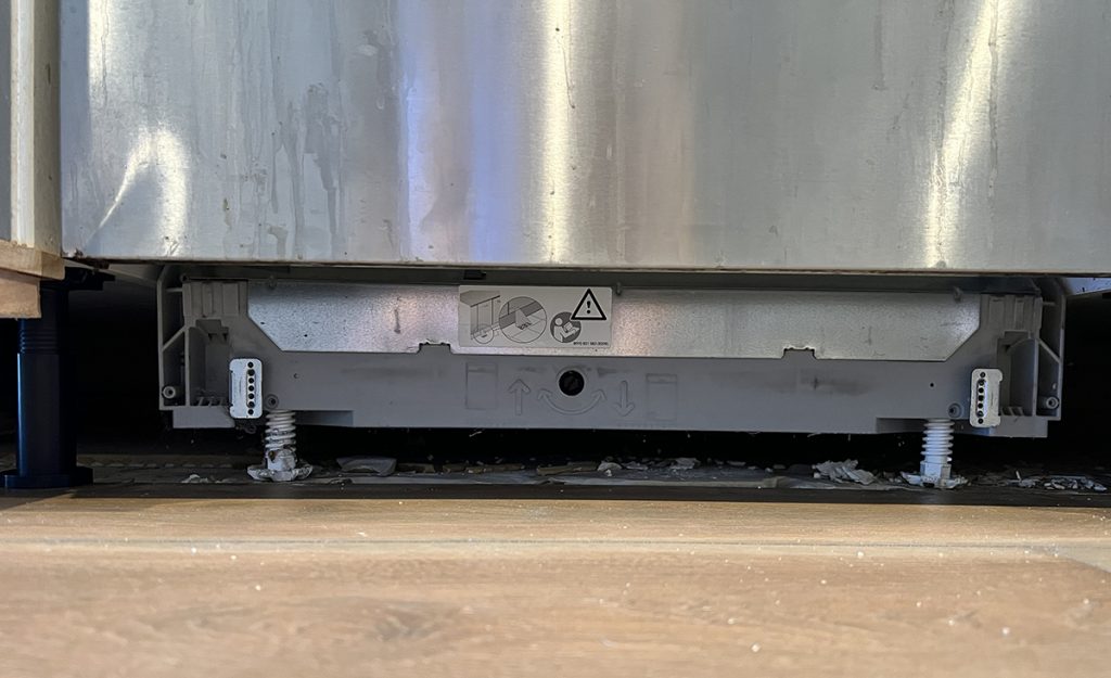 Upclose picture of the dishwasher legs and their adjustments.