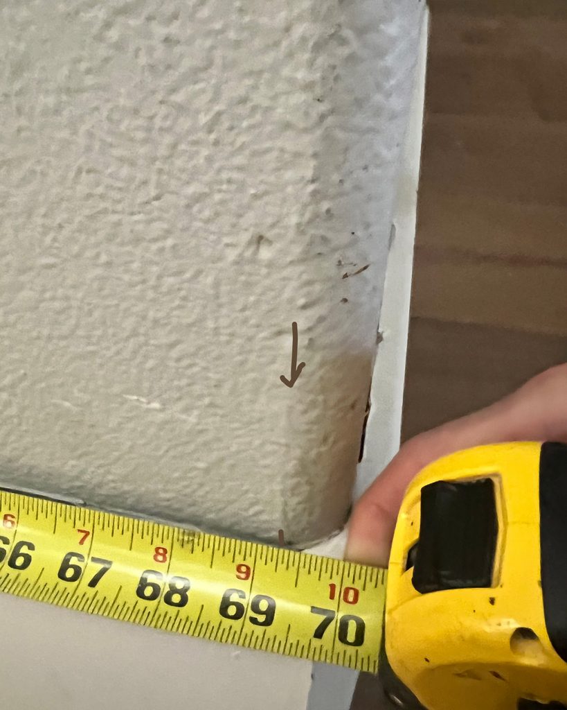 measuring tape held against a bullnose corner up to the shadow line created by the bullnose. This shadow line is where you measure to.