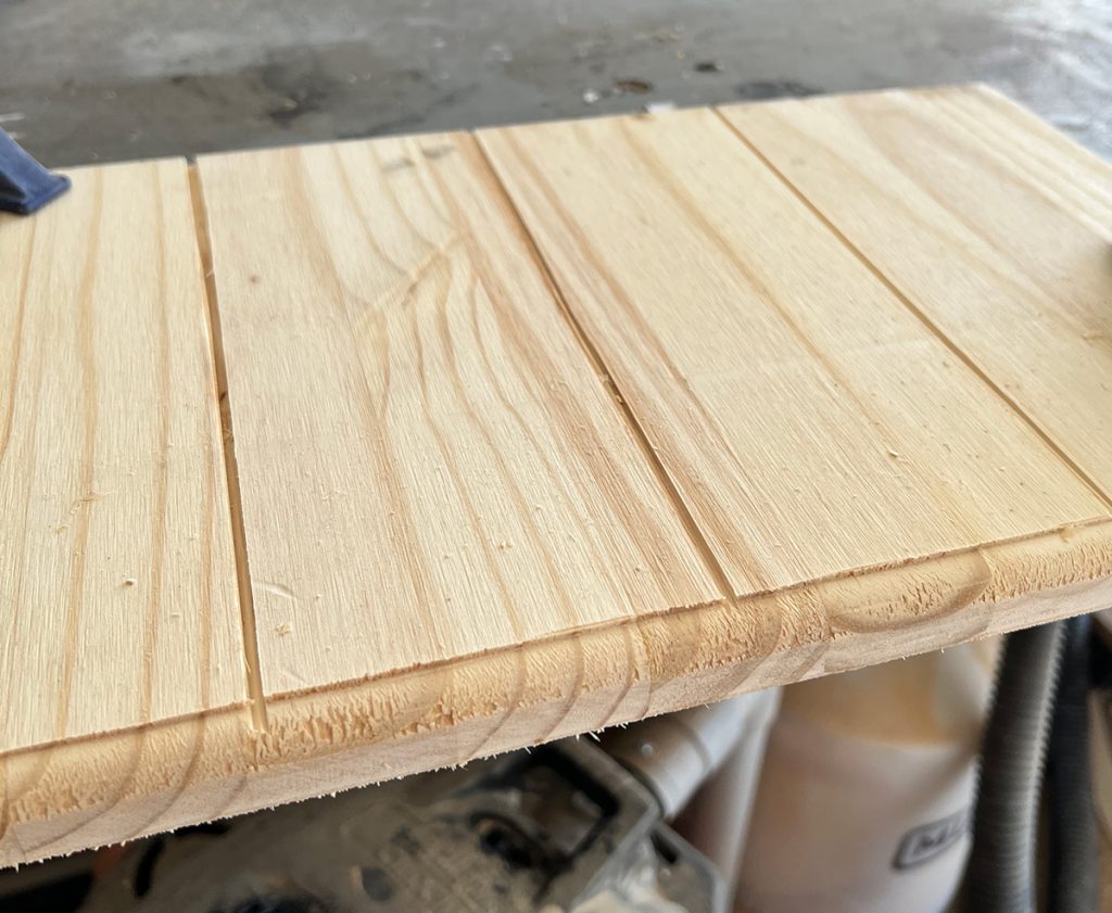 Pine scrap is clamped to the tablet top. Using a scrap board is a great way to practice your router profile and table finish. 