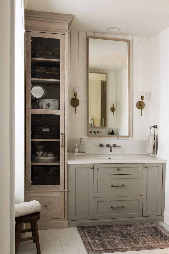 white washed oak linen cabinet with rubio monocoat cotton white is the perfect counterpart to the custom vanities painted feldspar pottery standing in front of vertical shiplap walls painted benjamin moore simply white.